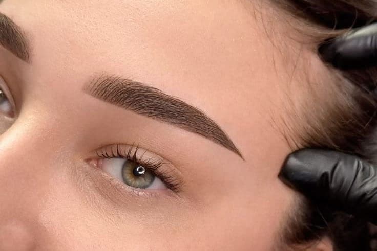 Healed powder brows with soft, evenly shaded colour, denser through the tail and lighter at the front